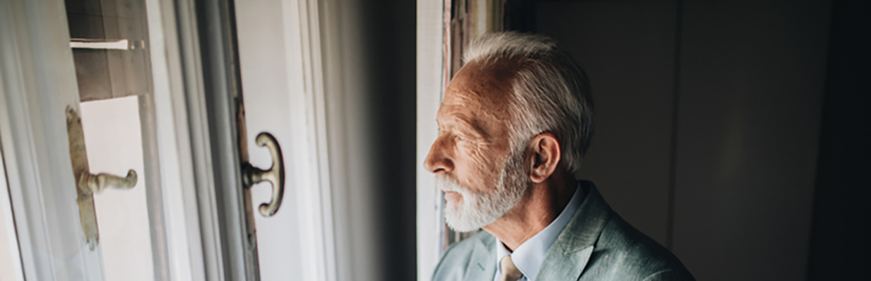 man in front of a window looking outside